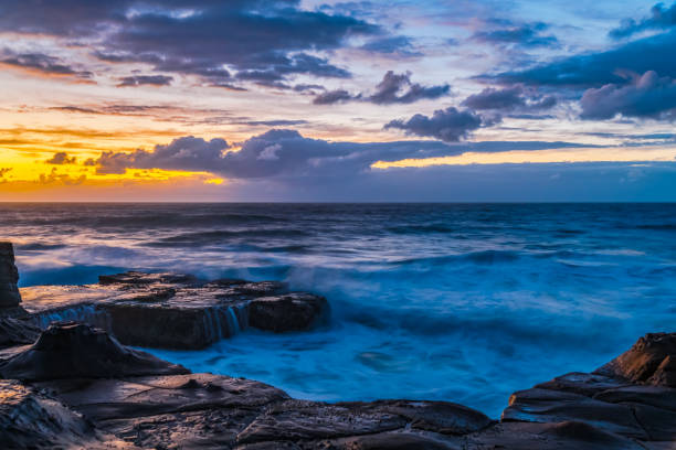 istock Sunrise, sea, waves, clouds and tessellated rock platform 2152694270