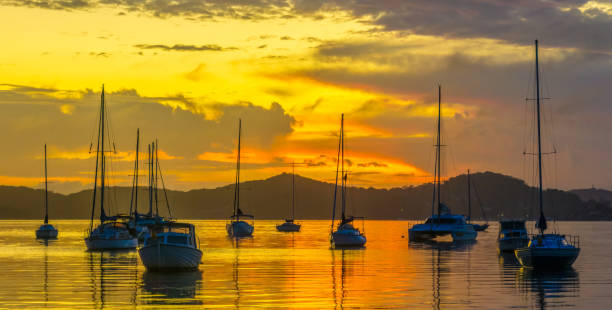 istock Aerial sunrise waterscape with boats, clouds and reflections 2152694271