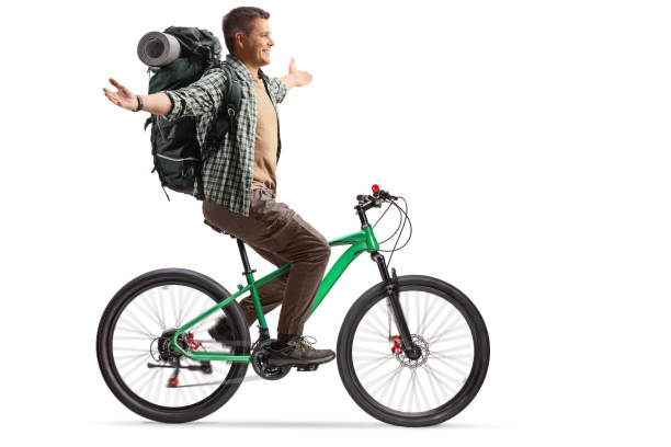 istock Full length profile shot of a young man with a backpack riding a bicycle 2152694528