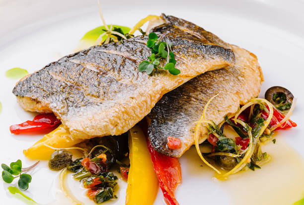 istock Gourmet pan-seared fish with vegetable garnish 2152694896
