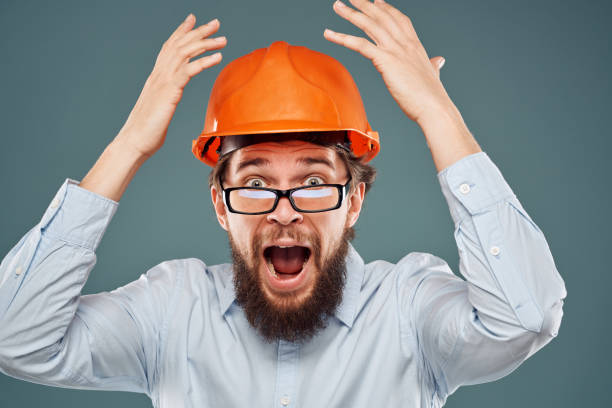 istock After wearing orange helmet shirt glasses hand gestures cropped view industry construction 2152695430