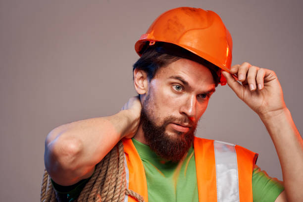 istock man in construction uniform orange hard hat construction cropped view 2152696326