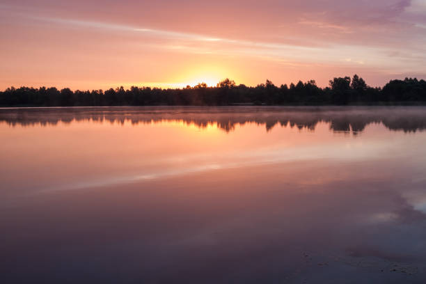 istock Sunrise over the forest lake 2152696543
