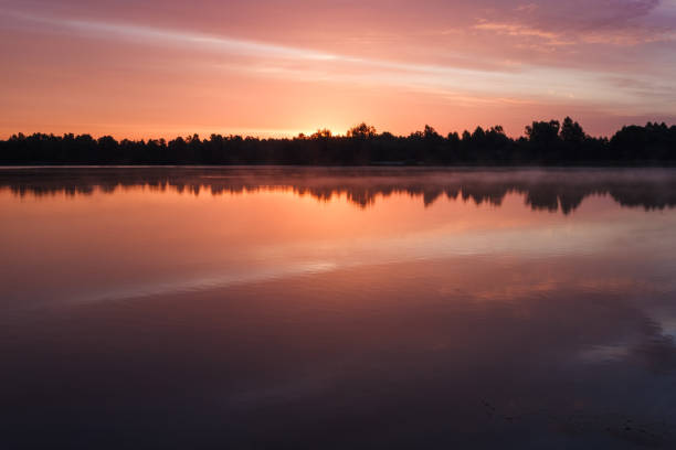 istock Sunrise over the forest lake 2152696568