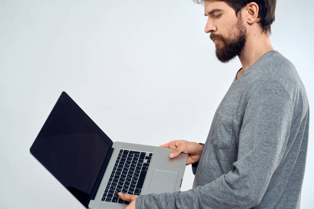 istock A man in a gray sweater with a laptop hands lifestyle technology communication internet work 2152696689