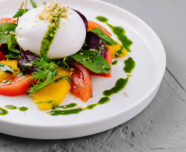 istock Fresh caprese salad with pesto drizzle on plate 2152697383