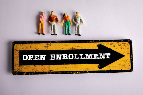 istock Open Enrollment Concept. Miniature human figures on a white background 2152697958