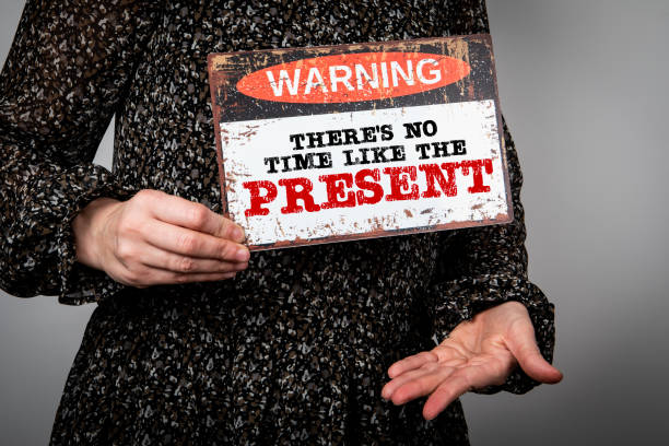 istock There's No Time Like the Present. Warning sign in woman's hands 2152698017