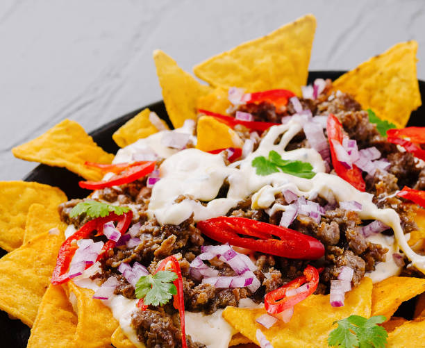 istock Loaded nachos on cast iron skillet 2152698492