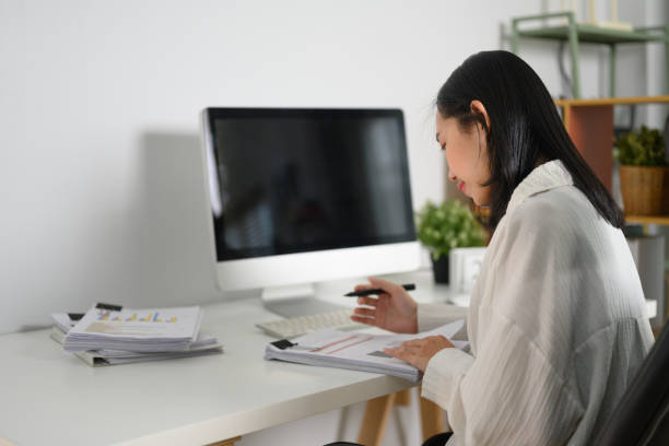 istock Focused businesswoman analyzing financial report at her workplace 2152700428
