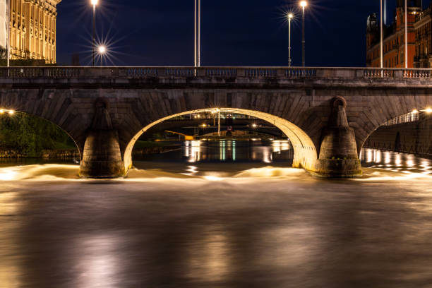 Double decker bus on Waterloo Bridge over the Thames at night.