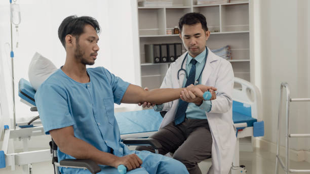 istock Professional physical therapist examines and cares for a young man in a physical therapy center, treating muscles and injuries of a man in a hospital. 2152701718