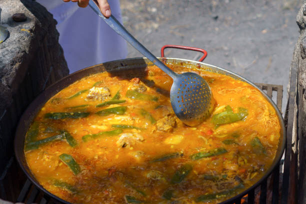 istock hand of a cook cooking a typical Spanish paella 2152701777