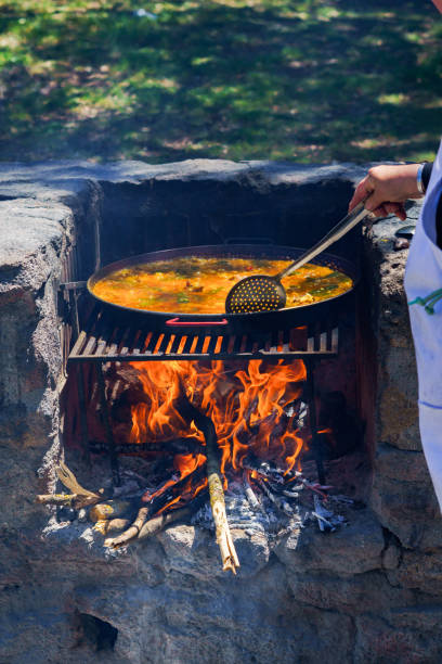 istock hand of a cook cooking a typical Spanish paella 2152701792