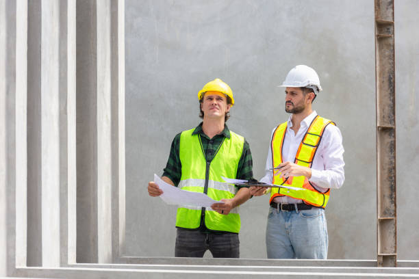 istock Engineer and foreman worker team checking project at precast factory site, Engineer and builders in hardhats discussing on construction site 2152703650