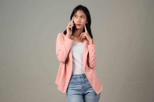 istock pensive asian woman talking on phone with worry expression on her face on isolated background 2152704467