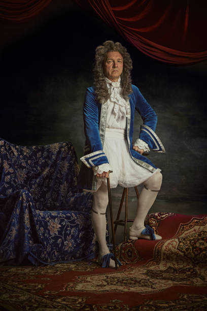 istock Portrait of elderly man dressed as medieval person, aristocrat with confident expression against vintage studio background. 2152704688