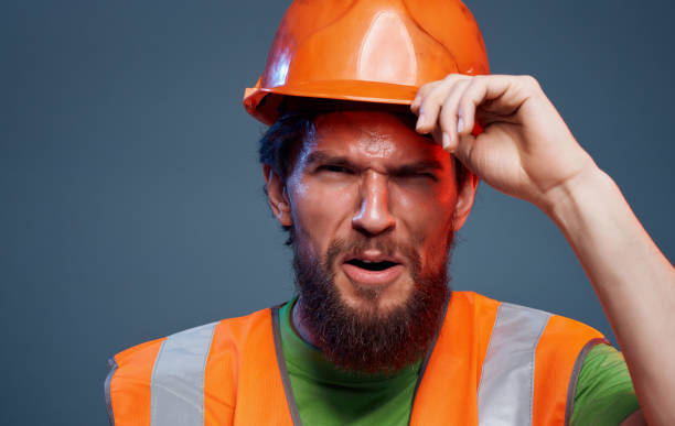 istock Male worker in orange paint emotions construction studio 2152707882