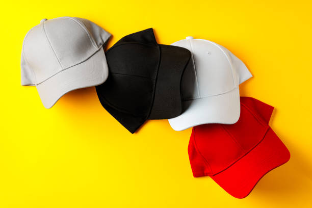 istock Baseball hat against yellow background in studio 2152710261