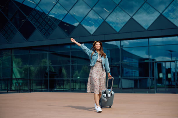 istock Young woman feeling excited while going on vacation at the airport. 2152712301