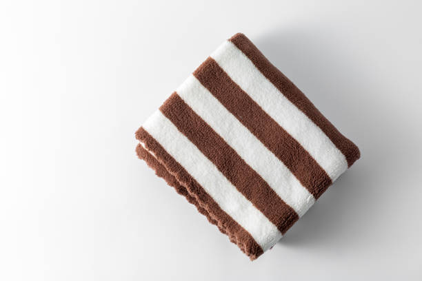 brown and white towel on white background