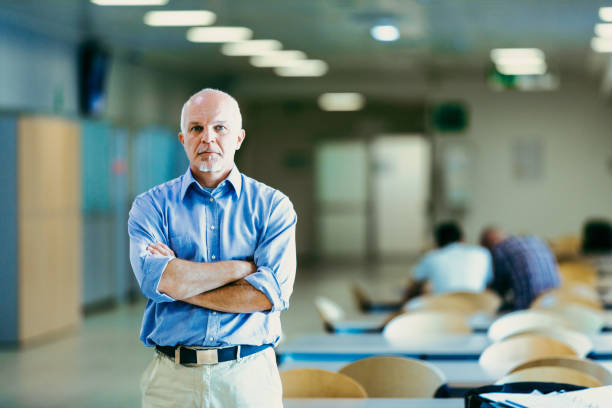 istock Confident man stands in office, arms crossed 2152713476