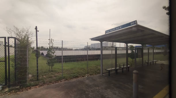 bus stop with a solar farm behind the fence