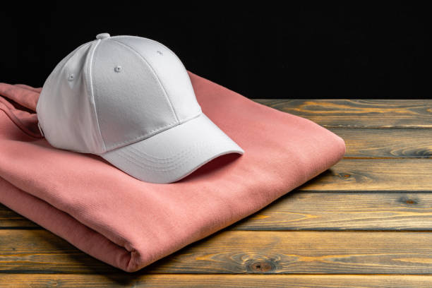 istock Trainers and baseball cap on wooden background 2152716505
