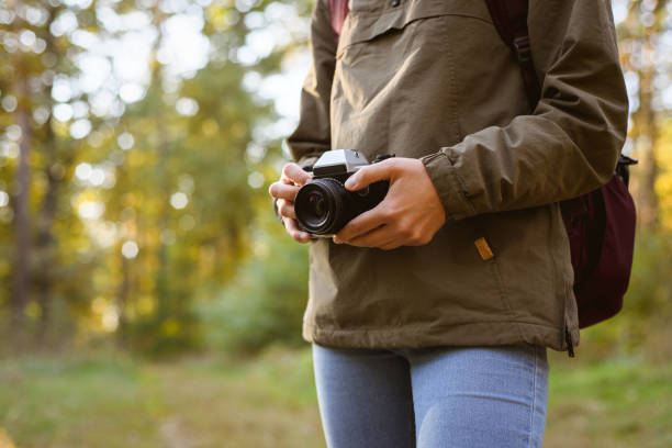 istock Hiker holding film camera in blurred forest 2152717556