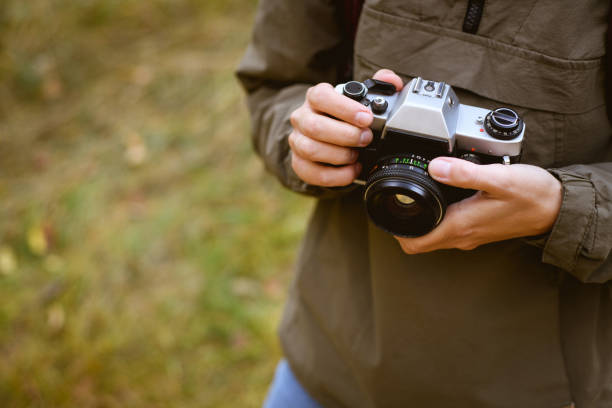 istock Woman holding film camera in forest 2152717571