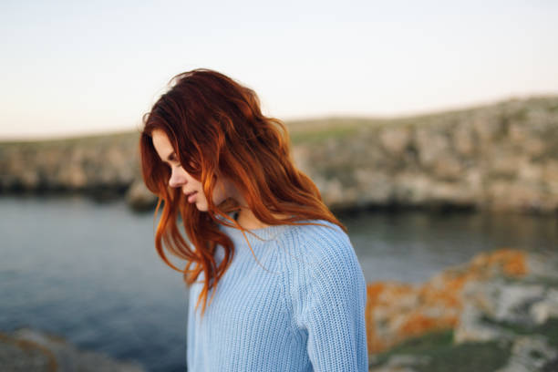 istock red-haired woman in sweater outdoors rocky mountains vacation 2152717621
