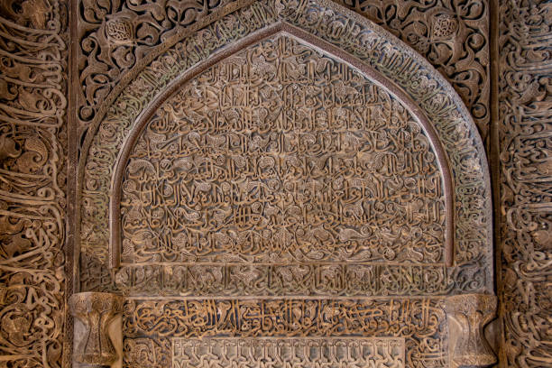 Bukhara, Uzbekistan - October 4, 2024: Muslim men pray in an iwan of Bolo Haouz Mosque at Bukhara, Uzbekistan. Iwan is the summer part of the mosque where Muslim believers pray.