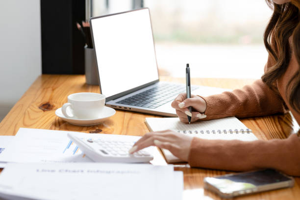 istock Focus on businesswoman using calculator to manage finances on documents. 2152718622