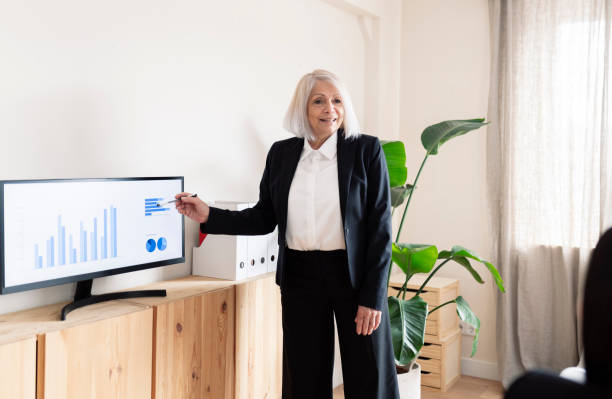 Senior Businesswoman Presenting Corporate Data