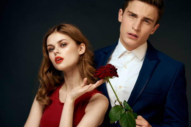 istock young couple hugs charm red rose relationship black background 2152719259