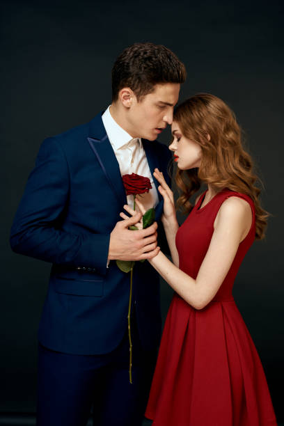 istock luxury couple hug romance relationship rose over dark isolated background 2152719441