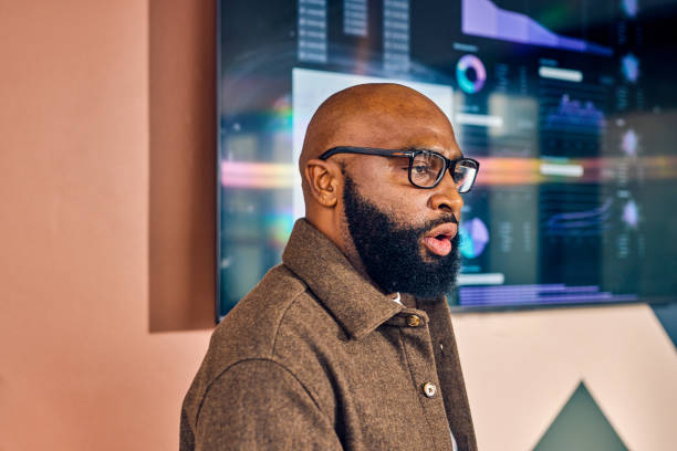 istock African American businessman presenting data analysis on a screen in a conference room. Professional presentation and strategic planning concept 2152719768