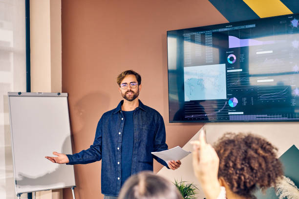 istock Caucasian male presenting data analysis on a screen in a conference room. Professional presentation and strategic planning concept 2152719769