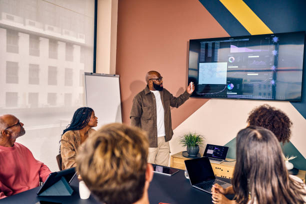 Multiracial business team in a meeting with data analysis presentation in a modern office. Corporate strategy and analytics concept