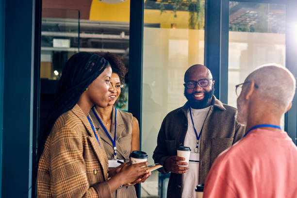 istock Multicultural business team during a coffee break in a corporate setting. Casual networking and employee engagement concept for design and print. 2152719828