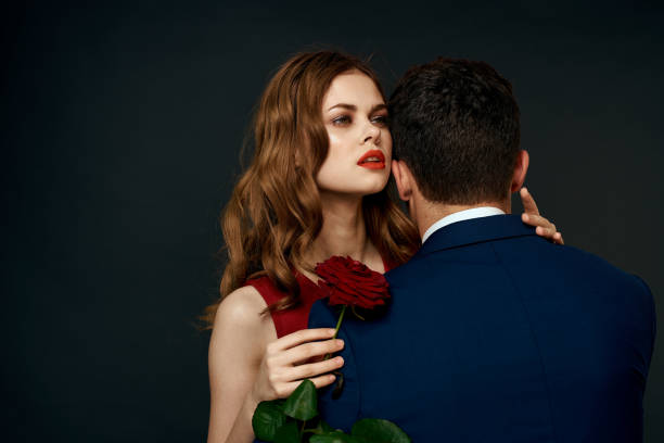 istock luxury couple hug romance relationship rose over dark isolated background 2152721664