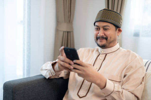 istock The Asian Muslim man is using the phone at home. 2152722213
