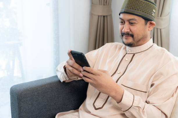 istock The Asian Muslim man is using the phone at home. 2152722215