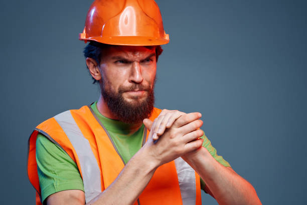 istock Angry man in work uniform orange paint safety hard work cropped view 2152722675