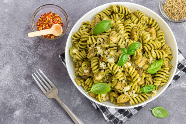 istock Basil Pesto Chicken Pasta Made with Fusilli, Served with Herbs, Chilli Flakes and Fresh Basil Leaves 2152725292