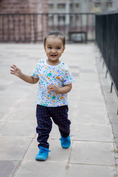 istock cute infant innocent action close up shot at outdoor from different angle 2152725661
