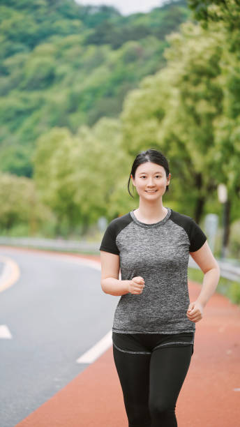 istock Young Woman Enjoying Her Jogging Routine in Nature 2152727565
