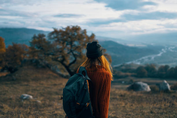 istock woman hiker with backpack on nature landscape dog 2152727778