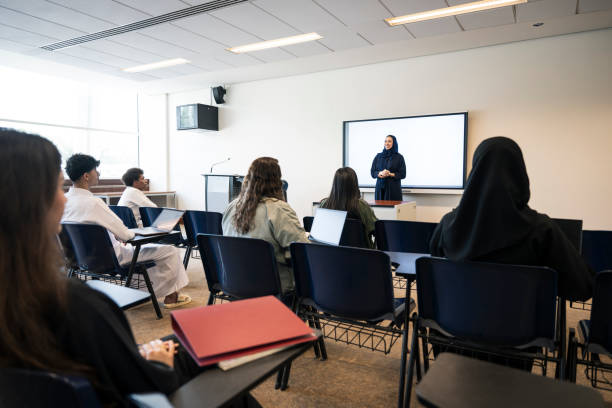 istock Coeducational group listening to female professor 2152729146