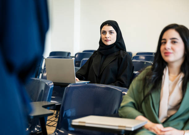 istock Two university students listening to educator in classroom 2152729183